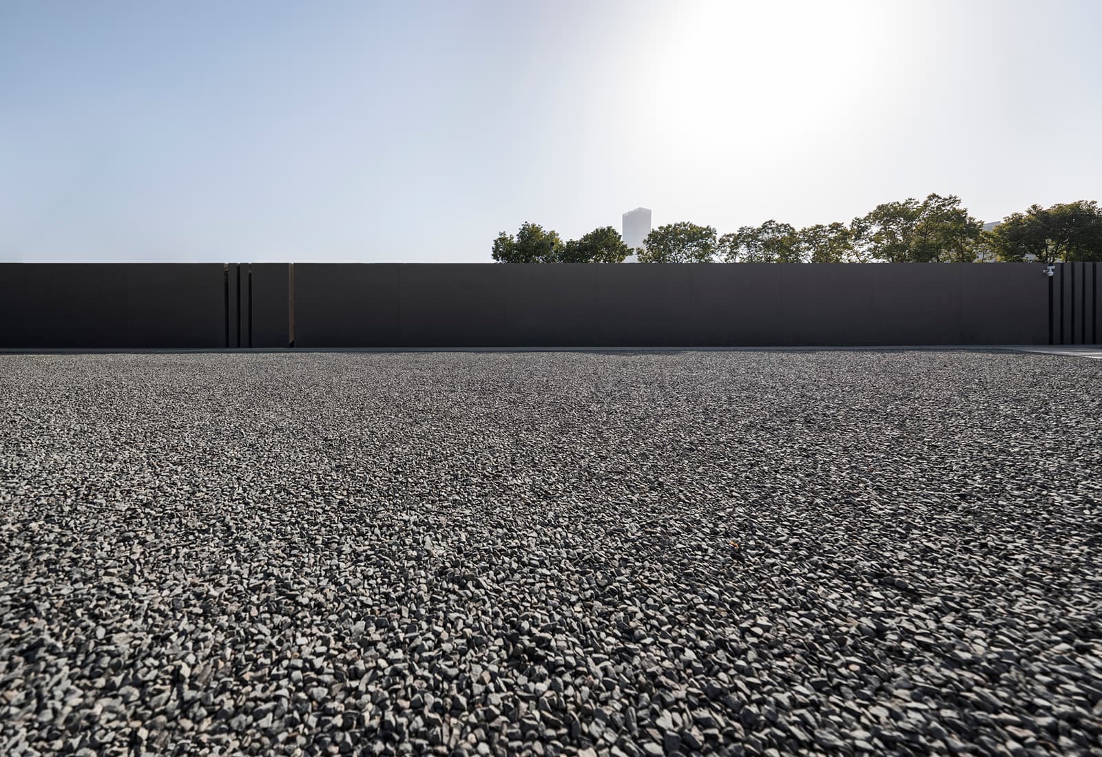 Close-up of a tar and pea gravel built-up roof surface