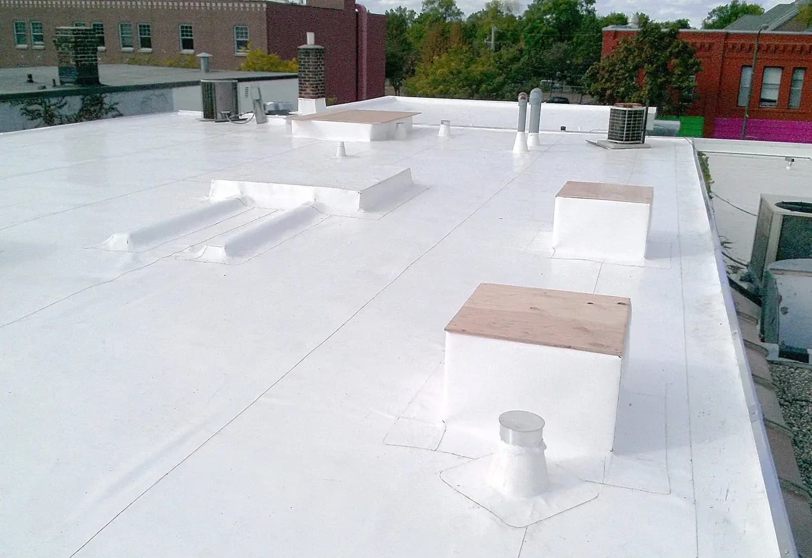 Completed white IB PVC roof with welded seams and flashings
